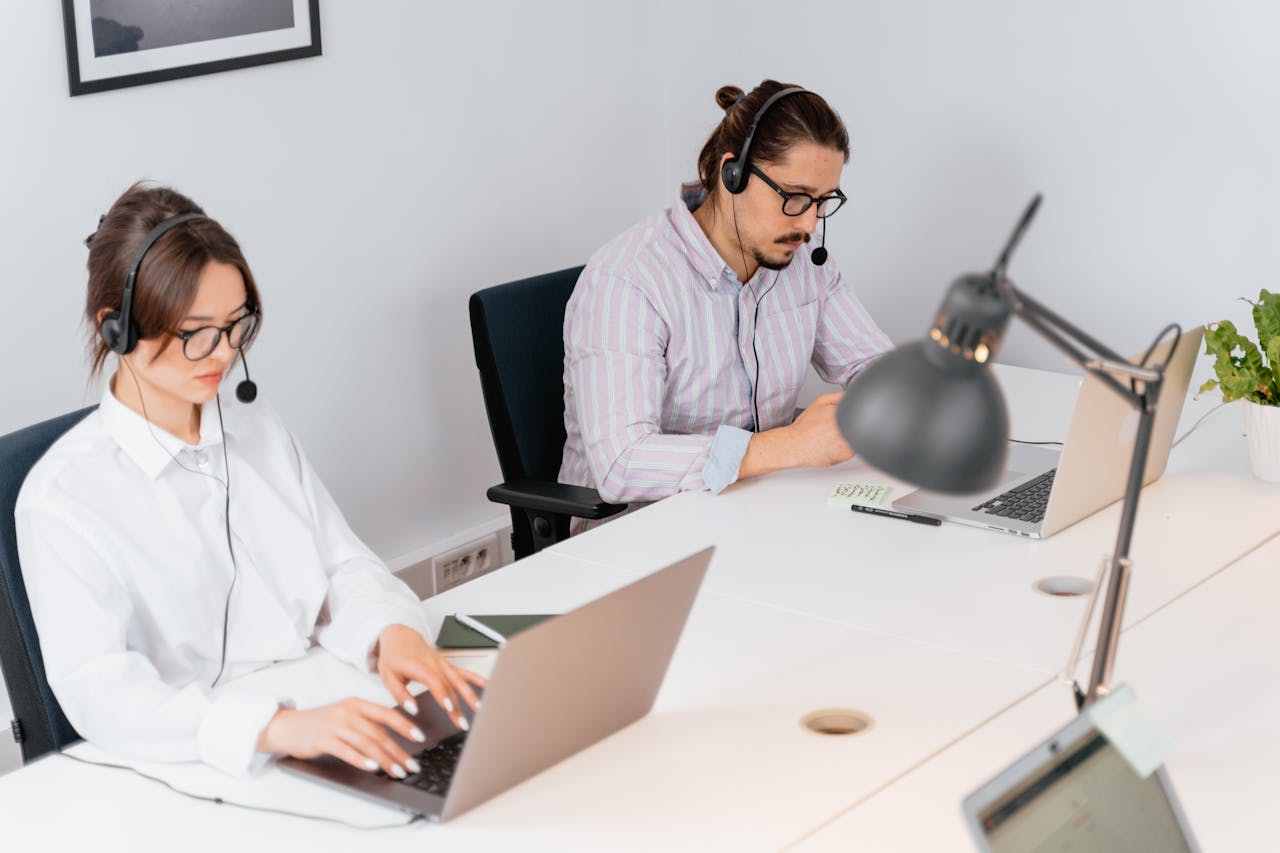 A Man and a Woman Using Their Laptops